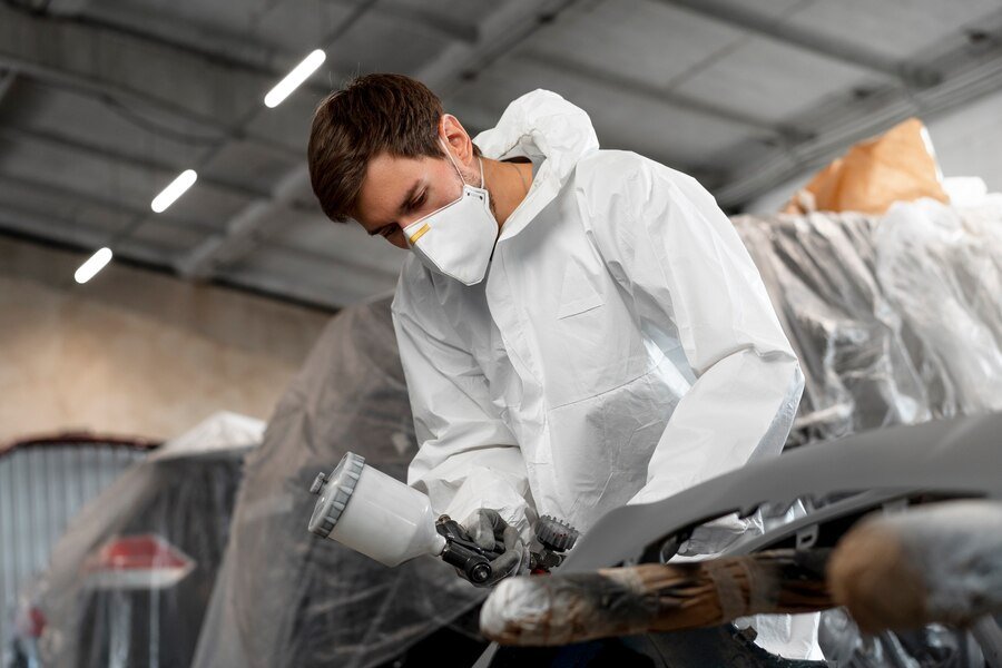 male-painter-dressed-hazmat-suit-inside-car-shop_23-2149750017